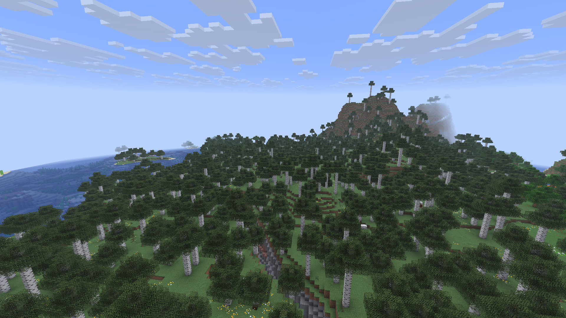 緑の森と青空が広がるMinecraftのワールド